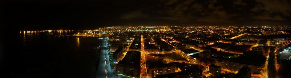 High angle view of illuminated city buildings at night