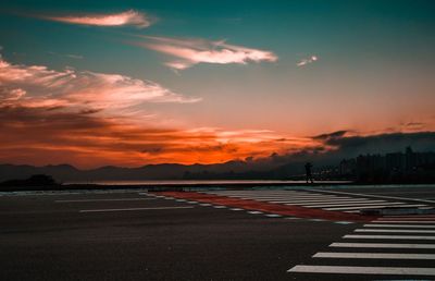 Scenic view of road against sky during sunrise