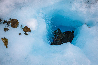 High angle view of glacier melting during winter