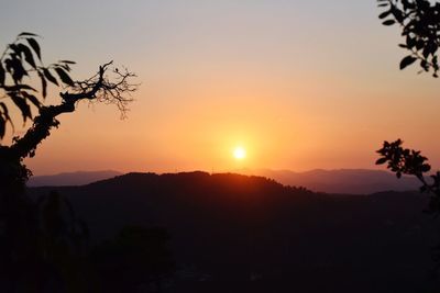 Scenic view of silhouette mountains against sky at sunset