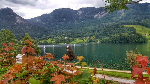 Scenic view of lake by mountain against sky