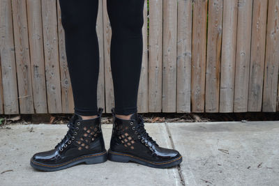 Low section of woman standing on tiled floor