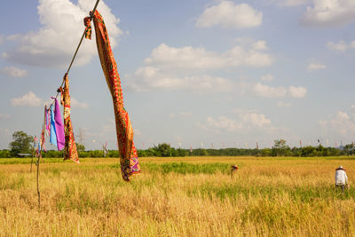 Traditional windmill on field against sky