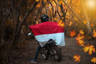 Rear view of man riding bicycle during autumn