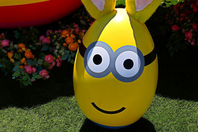 Close-up of yellow toy in field