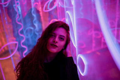 Portrait of young woman in illuminated light