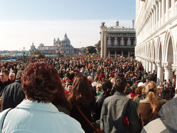 People in front of buildings in city