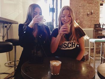Portrait of a young woman sitting on table