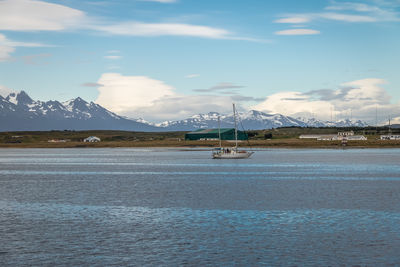 Scenic view of sea and mountains against sky