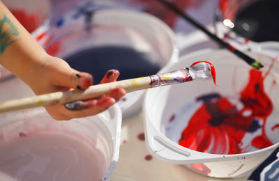 Close-up of girl hand holding paintbrush