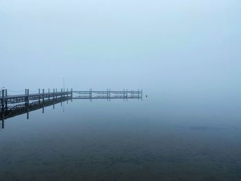 Pier over lake against sky