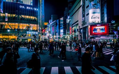 People on city street against buildings at night