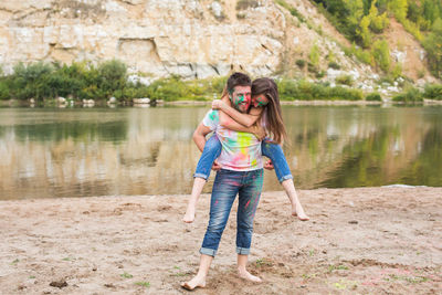 Full length of girl holding woman in lake