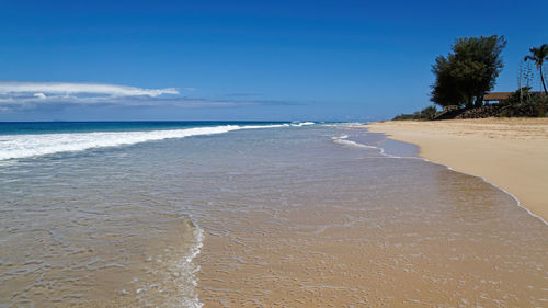 View of beach against blue sky