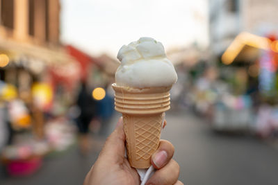 Hand holding ice cream cone