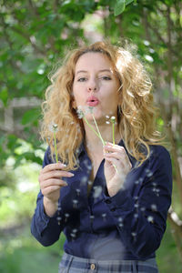 Portrait of beautiful young woman standing outdoors