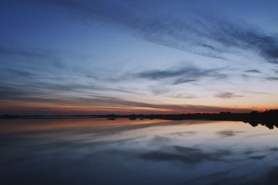 Scenic view of lake against romantic sky at sunset