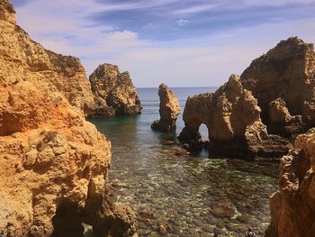 Panoramic view of rocks on sea against sky