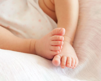 Close-up of baby lying on bed