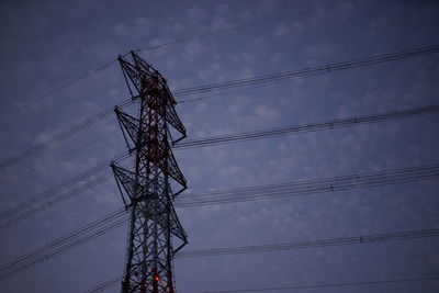 Low angle view of electricity pylon against sky