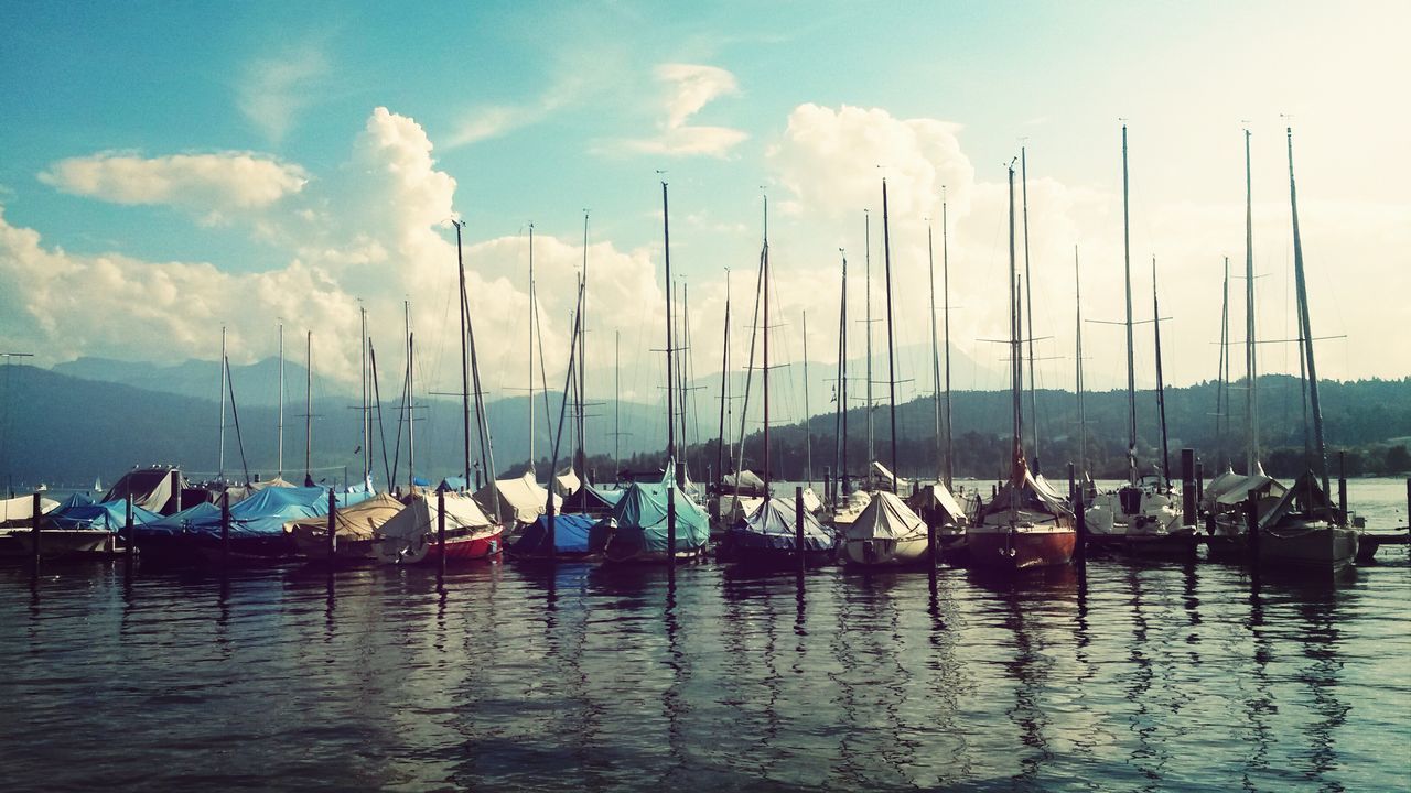 nautical vessel, water, transportation, boat, moored, mode of transport, sky, waterfront, mast, sailboat, reflection, cloud - sky, harbor, sea, tranquility, nature, lake, cloud, tranquil scene, scenics