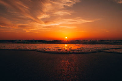 Scenic view of sea against romantic sky at sunset