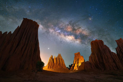 Panoramic view of rock formations with milkyway