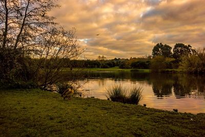 Scenic view of lake against cloudy sky