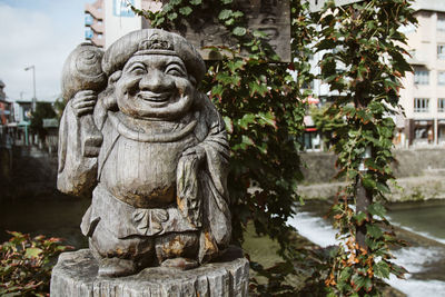 Statue against stone wall