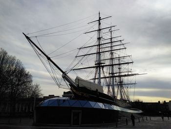 Sailboat moored in sea against sky