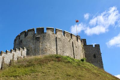 Low angle view of historical building against blue sky