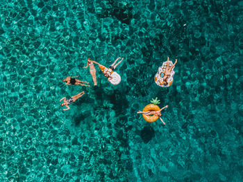 High angle view of people swimming in sea