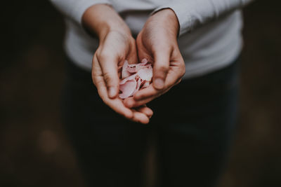 Close-up of woman holding petals