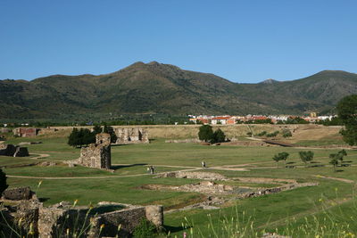 Scenic view of landscape and mountains against clear sky