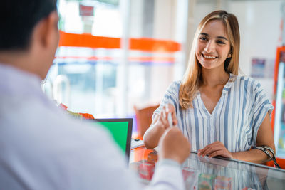 Young woman using mobile phone at office