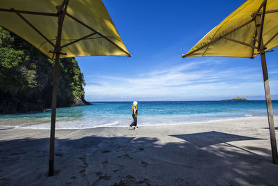 Man standing on beach against sky