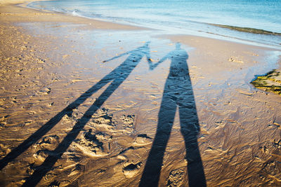 Shadow of people on beach