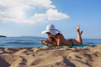 Woman enjoying summer vacation on the beach in heraklion, greece