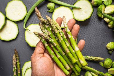 High angle view of hand holding vegetables