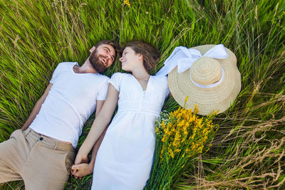 Young couple kissing on field