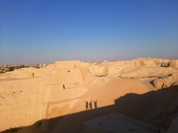 Scenic view of desert against clear blue sky