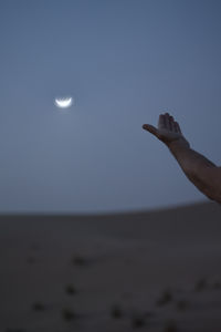 Hands of the man during spotting of the crescent