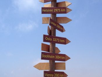 Low angle view of signboard against sky