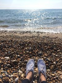 Low section of person standing on beach