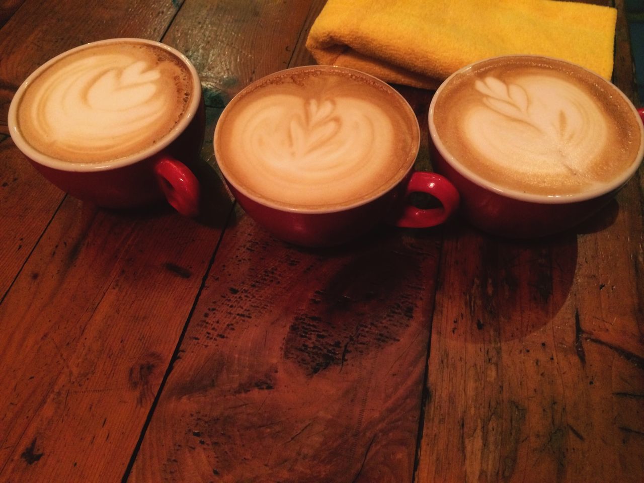 table, indoors, wood - material, food and drink, still life, wooden, freshness, high angle view, coffee cup, drink, coffee - drink, refreshment, brown, saucer, wood, directly above, close-up, heart shape, no people, cup