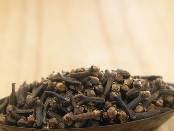 Close-up of dry cloves in bowl on table