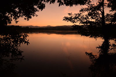 Scenic view of lake against romantic sky at sunset