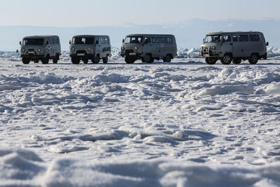 Cars on snow against sky