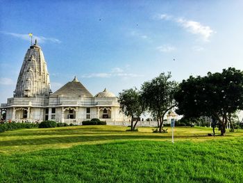 View of temple on field against sky