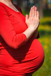 Midsection of woman holding hands